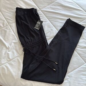 NWT- Women’s Strapless One Piece Pant Romper with Pockets. Gold accents.